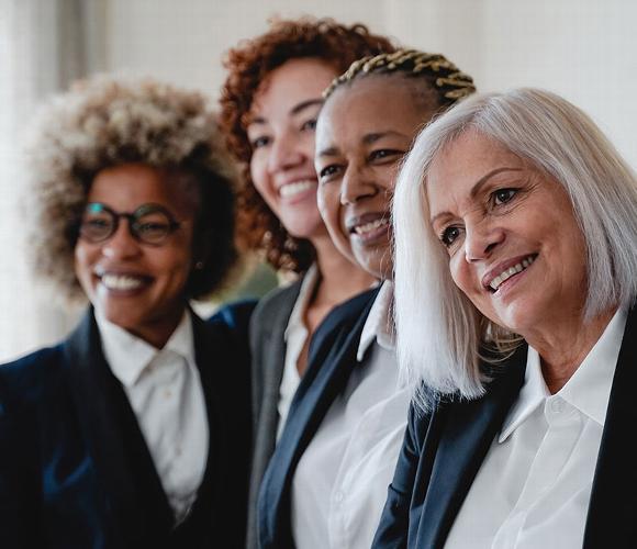 team of female lawyers of varying ages smiling