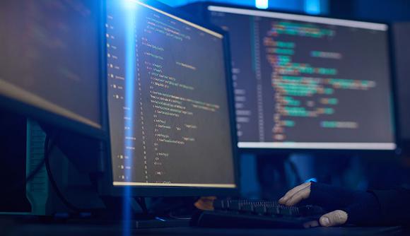 hacker looking through code